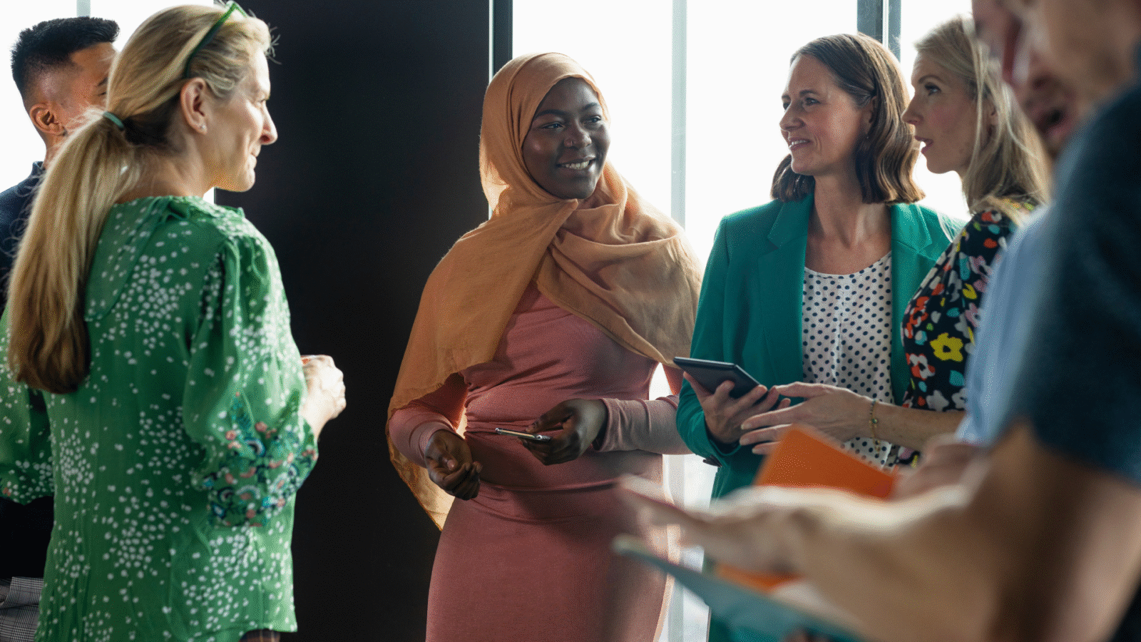 A group of women looking at their phones and tablets