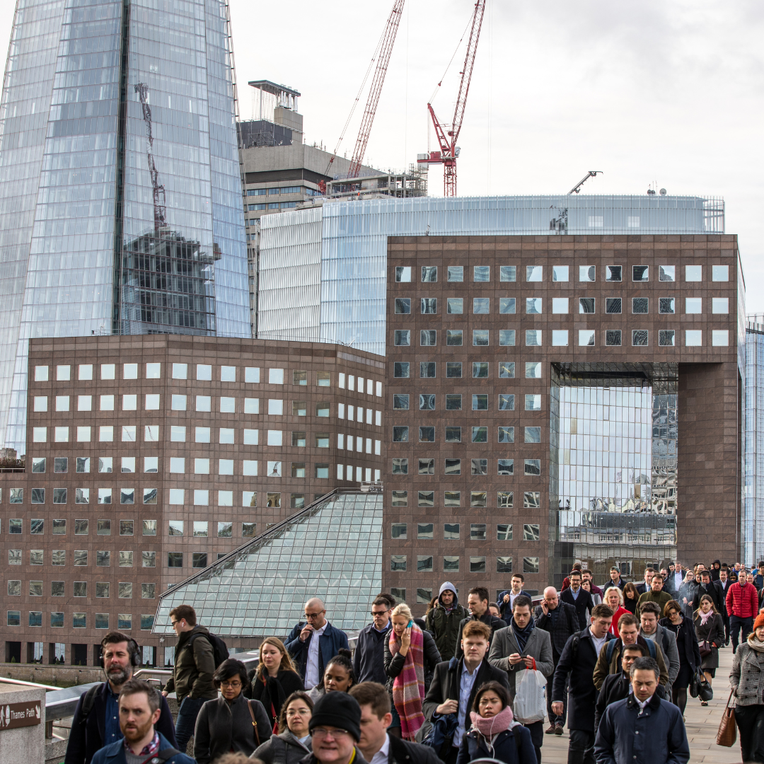 People of all ages walking outside in London with the Shard and other buildings in the background