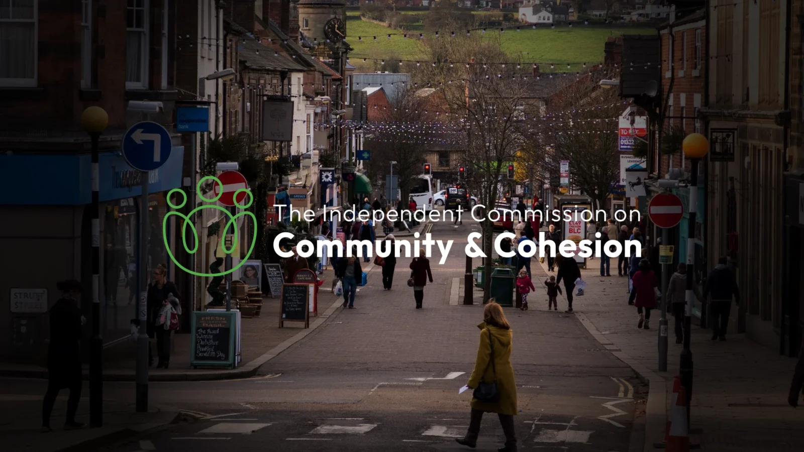 A UK high street with the Independent Commission for Community and Cohesion logo